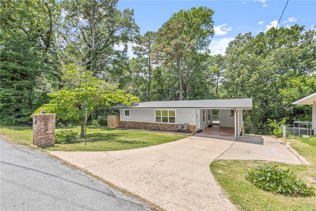 Move in ready with all the amenities that Bella Vista has to offer! This two bed one bath home, on a quarter acre lot, is perfect for small families or as a home away from home. Kitchen cabinets, backsplash, bathroom sink, and toilet all updated in the last 3 years. Septic updated in 2021. Shop in the basement is great for hobbies or to store mountain bikes! Mountain bike trails are a short ride from the house. Make this your home!