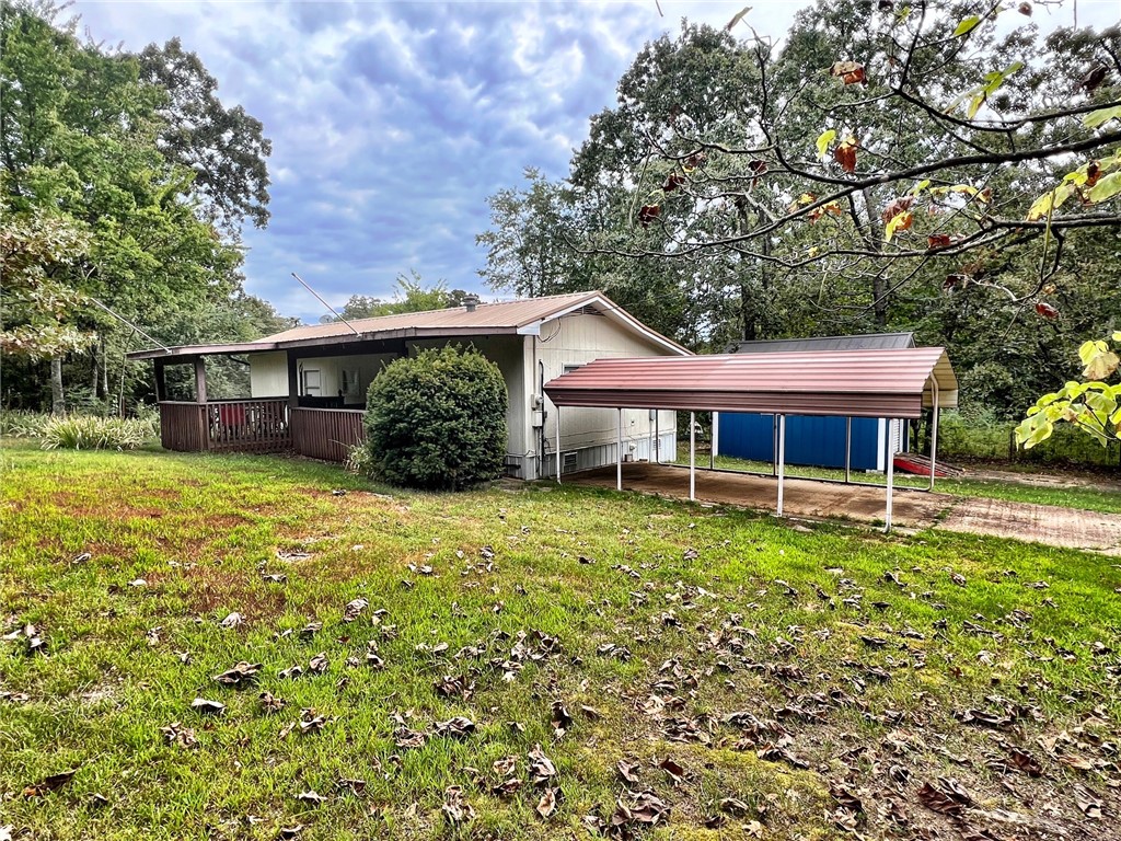 If you have been looking for that affordable lake get away, here it is. This 1 BR 1(updated) BA fully furnished mobile has had some recent updates and with the built on bunk room it has more room than you would think. It is situated on 2 lots totaling 100 x 105. This would be a great family getaway or if you have been wanting to test the waters on a nightly rental, this would be perfect. There is a 12 x 16 drive through shop to house that jet ski or lake toys. There are also 2 parking pads, one covered for your fishing boat!