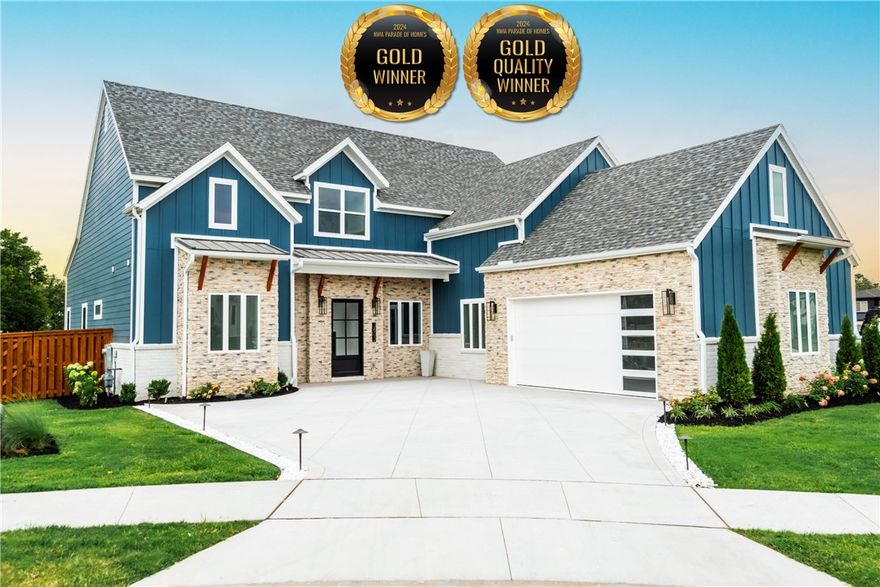 The 2024 Parade of Homes "Overall Gold" & "Quality Gold" medal winner! Discover the stunning two-story Ethan floor plan, thoughtfully designed for modern living with 3,498 square feet of elevated elegance & comfort. The kitchen, a centerpiece of luxury, features a premium curved quartz island, gold sink fixtures, & upgraded white Cafe appliances. Oversized windows & sliding glass doors blend indoor & outdoor spaces, including a tiled patio & enhanced landscaping. The main suite features walk-in closets & a luxurious bathroom with a separate tub &  shower, dual sinks, & a makeup vanity. Three additional bedrooms are complemented by 3.5 bathrooms, featuring extra storage & a secret play cubby. Real wood flooring, a herringbone-patterned entryway, & accent walls infuse the home with sophistication. The living spaces include a stunning fireplace, a loft with a beverage center, & a spacious pantry that includes a fridge & butcher block counters. The oversized 2 car garage is complete with an epoxy floor & ample storage.