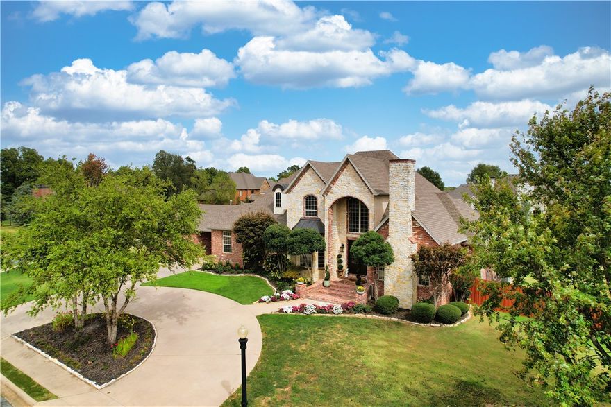 Stunning estate on nearly an acre in gated St. Valery Downs! Prime location near Bentonville/Rogers--short walk to Central Park Elementary. This beautifully landscaped, elegant, yet inviting home features beams, fireplaces, large windows, curved staircase & endless storage--upstairs game room w/wet bar & patio. Enjoy the cozy den w/fireplace. A chef’s kitchen offers island w/ sink, ample cabinets, built-in GE Monogram appliances & Viking 6-burner stovetop. All 4 roomy bedrooms have ensuite baths--2 on 1st floor. Primary suite boasts luxurious bath, double shower & vanities & custom-built spacious closet. Additional room could serve as office/exercise room. Multiple outdoor areas for entertaining include bar/sink area for watching the big game/ wood-burning fireplace for relaxing while cozying up on the porch swing/heated pool for swimming/ hot tub for soaking while taking in the beautiful NWA night sky—added amenities built-in grill & outdoor bathroom. Corner lot w/ oversized 2-car & single-car garage.
