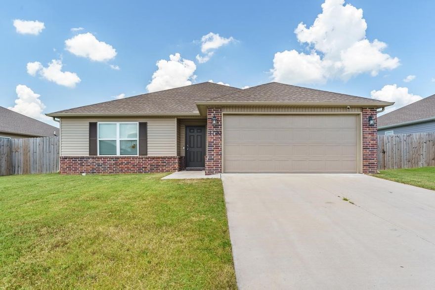 Welcome to 1720 Greenbank Drive in Centerton, AR. This 3-bed, 2-bath home was built in 2022 and has been immaculately cared for. The open concept living room & kitchen flow perfectly for entertaining and everyday living. The kitchen is at the heart of the home and features stainless steel appliances, bar seating space, beautiful counters and tons of cabinet space. The door off the dining space leads to the covered patio and fenced in backyard. Just off the kitchen is the laundry room and large pantry, which then leads to the 2-car garage. The primary suite is just off the living room and includes a large walk-in closet, walk-in shower, large countertop & floating shelves. Two additional bedrooms are at the front of the house near the secondary full bathroom. Beautiful LVP flooring flows throughout the main living area with carpet in the bedrooms. Located close to Centerton Gamble Elementary, Bentonville West High School & Kinyon Sports Complex.