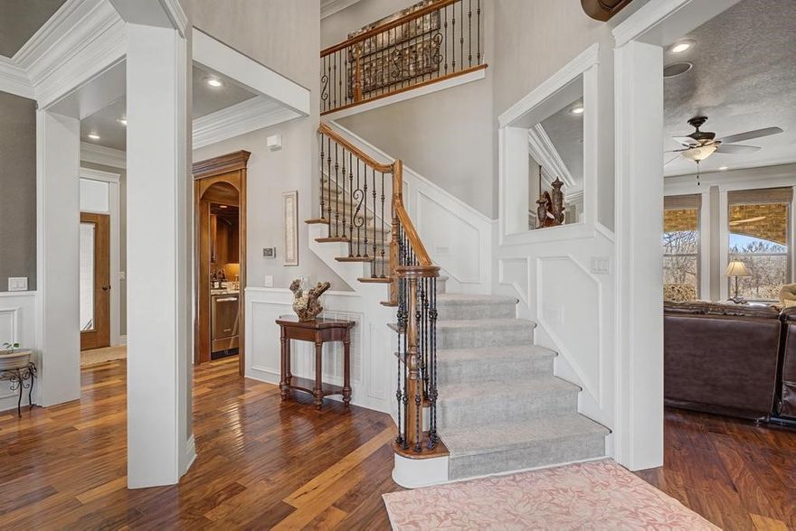 This exceptional custom-built home combines luxury craftsmanship with high-end upgrades throughout—all overlooking Brush Creek Golf Course. From the moment you arrive, the striking double wrought iron front doors set the tone for the quality found inside. The chef’s kitchen is a true centerpiece with a large copper farmhouse sink, complemented by a dedicated coffee bar with its own copper sink and a wet bar featuring a built-in ice maker. The spacious primary suite offers a spa-like retreat with a very large walk-in shower. Step outside to a beautiful half acre backyard featuring an underground sprinkler system, wrought iron fencing, and a large covered patio with a brick fire pit and built-in seating—perfect for relaxing while enjoying golf course views. Additional highlights : 400-amp electrical service with 50/30 amp RV hookups, Two gas tankless water heaters,Golf cart garage in basement.Major updates include both HVAC units replaced in 2018 (with remaining warranty) and a brand-new roof and gutters in 2025.