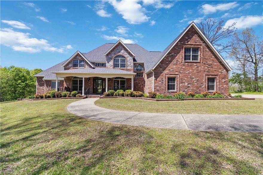 This beautiful property truly has it all! This estate home is nestled on a 3.9 acre lot covered with mature trees and is located near Siloam Springs City Lake with surrounding biking and walking trails. This beautiful 3 bedroom, 4 bath home features 3400 square feet with 2 levels which boasts an office and a large bonus room which could double as a mother-in-law suite as it includes a kitchenette and an attached bath. With many unique features including beautiful workmanship throughout, custom clad aluminum and wooden windows, soaring ceilings, central vac system, double ovens, and a second-floor primary suite with balcony, this home leaves nothing to be desired. The cherry on top is the massive detached garage with double garage doors, office space and a half bath. The exterior of the home features a custom pergola over the large back patio, landscaped flower beds surrounding the entire home and a designated garden area. Schedule your appointment to see it today!