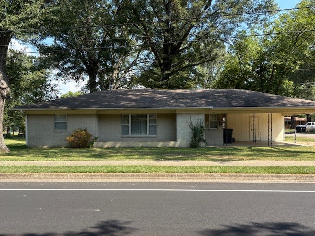 Perfectly located close to schools, shopping, hospital, and grocery stores. Large trees cover this corner lot. Living and dining. Kitchen with all appliances plus washer and dryer. 3 bedrooms, 1 1/2 baths. Patio. Storage room off of carport.