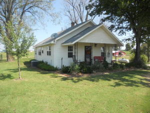 Very nice updated home on paved road. Has totally new kitchen, new plumbing, wiring, central H/A, septic, and windows. Large free standing carport, storage building, and more land available.
