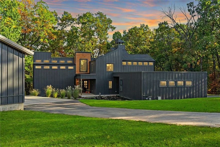 This Frank Lloyd Wright inspired home boasts a gorgeous ravine view! This modern marvel sits on 2.99 acres on a beautiful quiet street in a Prime Location offering all the privacy you could want. Located just 3 minutes to DT Rogers and 1 minute to Lake Atalanta, you could easily bike to all that Downtown Rogers offers. This showstopper has been taken down to the studs and remodeled with impeccable design features that were curated by local esteemed designer. Be prepared to be wowed with this one as every detail is perfection! Architectural drawings attached to MLS to show the thoughtfully executed plans and addition. This home offers 4 BRs, 3.5 baths, on 3 levels all featuring walk in custom closets. 2 master suites (main level and top floor), hidden pantry in the kitchen, wood flooring, large formal dining with custom built ins, gorgeous Venetian plastered fireplace, and open entertaining spaces. Large Shop on property is perfect to store all of your toys and cars. This home is a must see! Schedule your showing!