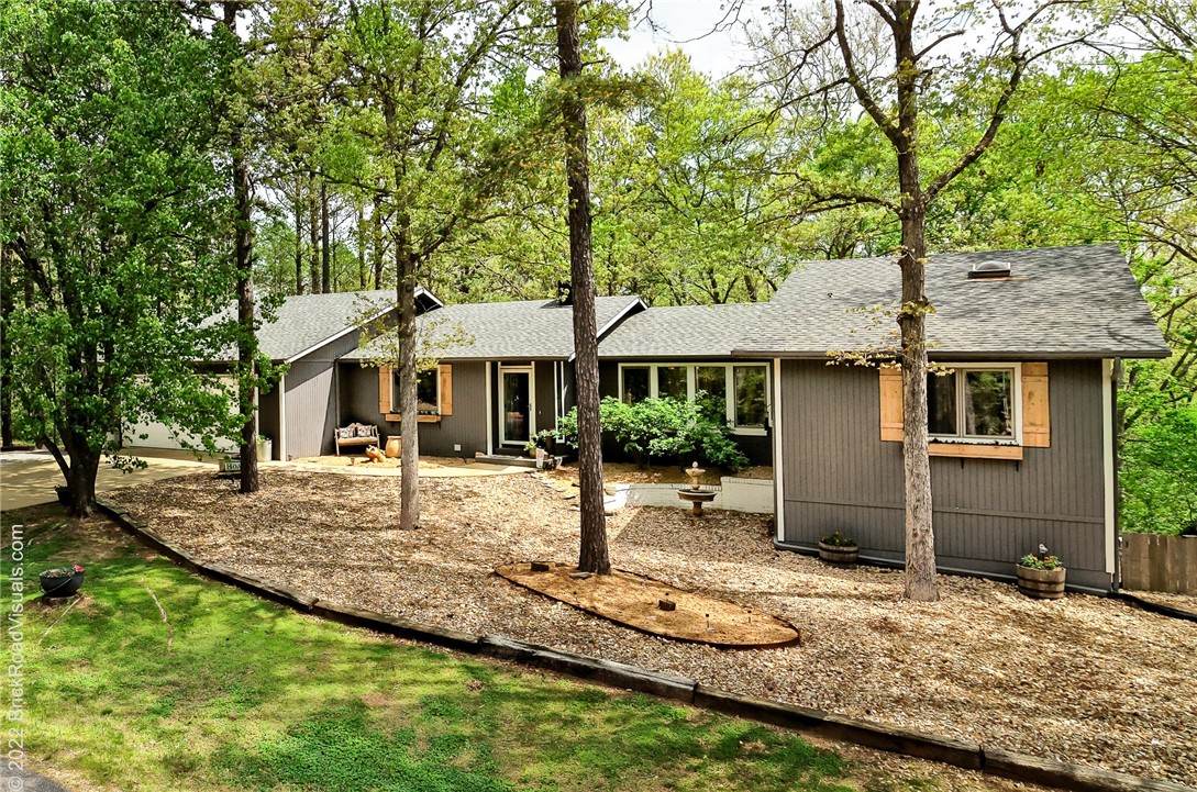 Immaculate home in the heart of Bella Vista. Some of the upgrades include, new flooring throughout, remodeled kitchen, remodeled bathrooms, new decking and so much more! This corner lot is on .48 acres. The upstairs main floor has the main bedroom, first guest bedroom, main living room and sunroom. Downstairs area includes second living room, second guest bedroom, bonus room with closet and access to an outside patio area.
