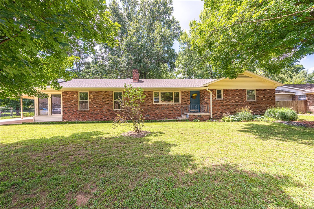 WELCOME HOME! This East Fayetteville 3 bedrm 3 bathrm home is in a premier location near shopping, eateries, schools, parks, Washington Regional, & College Ave! Head inside to the spacious front living room w/ wood flooring, built-ins, chair rail detailing, & brick wood burning fireplace! Off the living a formal dining room w/ abundance of natural light from the sliding glass door & built-in buffet table! L-shaped kitchen with plenty of room featuring abundant storage with white cabinetry & a stainless steel gas range! This split floor plan home features two large bedrooms and a full bathroom! Through the kitchen you’ll find a second living room with wood look tile flooring great for hosting guests! Enjoy your sunroom hallway with skylights to your oversized primary bedroom oasis with built-ins and private ensuite w/ dual sink vanity, & separate tub & walk-in shower! Head out back to the large deck overlooking the back lawn with mature trees brick patio, and storage building! Don't Miss Out! Act Now!