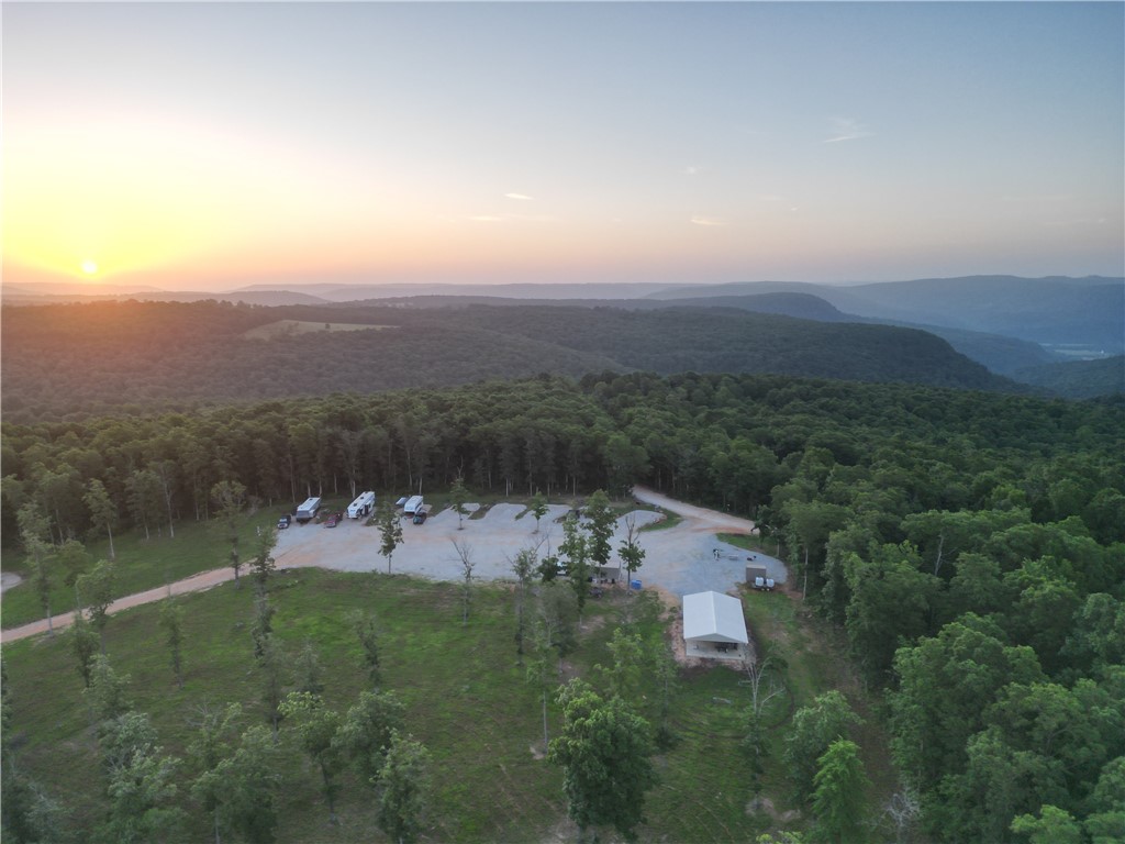 Turnkey 8-acre RV park + cabin retreat minutes from the Buffalo National River and Wilderness Rider Buffalo Ranch. Developed in 2022, it features nine full-service RV sites (level gravel pads with water, 30/50-amp electric and sewer), each with a picnic table, fire pit and charcoal grill. Pet-friendly with proven rentals; cash-flows with room to expand. Two furnished cabins include full kitchens, king beds, Smart TVs, private baths and futons, plus covered porches with swings for sunsets. A shared pavilion adds picnic seating, cornhole and Wi-Fi TV. Utilities include underground electric, septic and HVAC (mini-splits/A-C). Currently on a shared wellāseller will drill a new well with an acceptable offer or install larger holding tanks with a shared-well agreement. Rolling, wooded terrain in Madison County near the Newton line on a county road; metal roof/siding; block crawlspace. No zoning; currently operated as a recreational hospitality business.