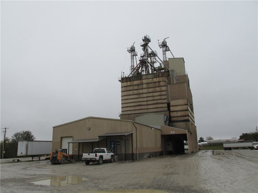 The property is currently improved as a feed mill operation. The improvements consist of +/-13,858 gross square feet. The property includes a standalone, office building, feed mill and 3 small outbuildings. There are several tanks and storage bins typical of feed mill operations. Additional improvements include gravel parking/drives and signage.