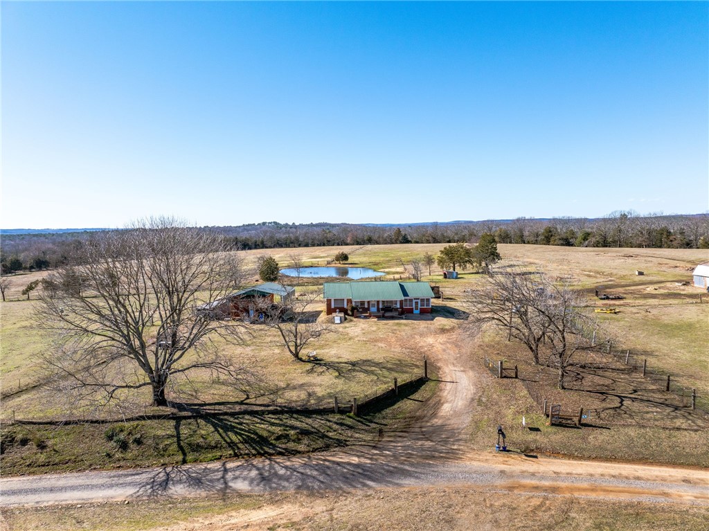 Updated 3 bedroom, 1 bath brick home, carport converted to living area,(extra 280 ft.), metal roof, S/S appliances, new paint, carport, tile & laminate floors, updated electric. Window air (6), & gas heaters. 500 gallon Propane tank conveys, Gryner built storm shelter, 16x40 building with window air & gas heat. 28x32 steel awing for parking, 2 ponds, newer fence & cross fences, tractor shed, small loaf shed, old barn. 3 wells on property, rural water to home, fiber optic WAVE internet, 2 horse stalls, & small Corral. List agent is related to seller.