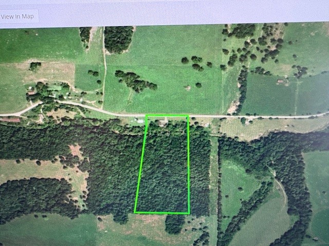 Mobile encapsulated and 500 sq. ft. added with roof over entire home..sits on 15.05 acres with pond and stream running across just before rising to wooded hill with view at the top. Mostly hardwood with a little clearing. Owner says good well and septic. Located between Berryville, Hwy 412 and Green Forest just off Hwy 21 South. Approximately one hour to Branson north or Fayetteville to the west. Some TLC needed and being sold AS IS but potential to update although is occupied now. Building in back needs to be removed.