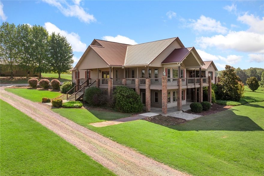 Discover panoramic views of Gaither Mountain from this 5 bed, 3 bath home on 13.76 acres with over 8,290 sq ft of living space. Features include two full kitchens, a spa-like primary suite with zoned HVAC, hardwood floors, vaulted ceilings, wrap-around porches on both levels, and a safe room with dual access. A 30x40 shop offers full living quarters and workshop. Tech upgrades include Ring security on all exits, app-controlled Samsung and LG appliances, a Moore water system with RO, Refiner softener, Cisco business-grade WiFi, and a pro-installed internet bridge from shop to house. Solar panels keep electric bills around $175/month, and fiber internet is coming soon. Located near Harrison in Boone County—just minutes from the Buffalo River and a short drive to White River, Kings River, Bull Shoals, Norfork & Table Rock Lakes—this property offers the perfect blend of seclusion, luxury, and access to world-class outdoor recreation.