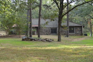Beautiful country home with unique architecture and many great features including a nice sunroom, spacious living area with cozy fireplace, 1650 sqft of living area, 1.48 country acres, pretty landscaping and a 20x30 shop!