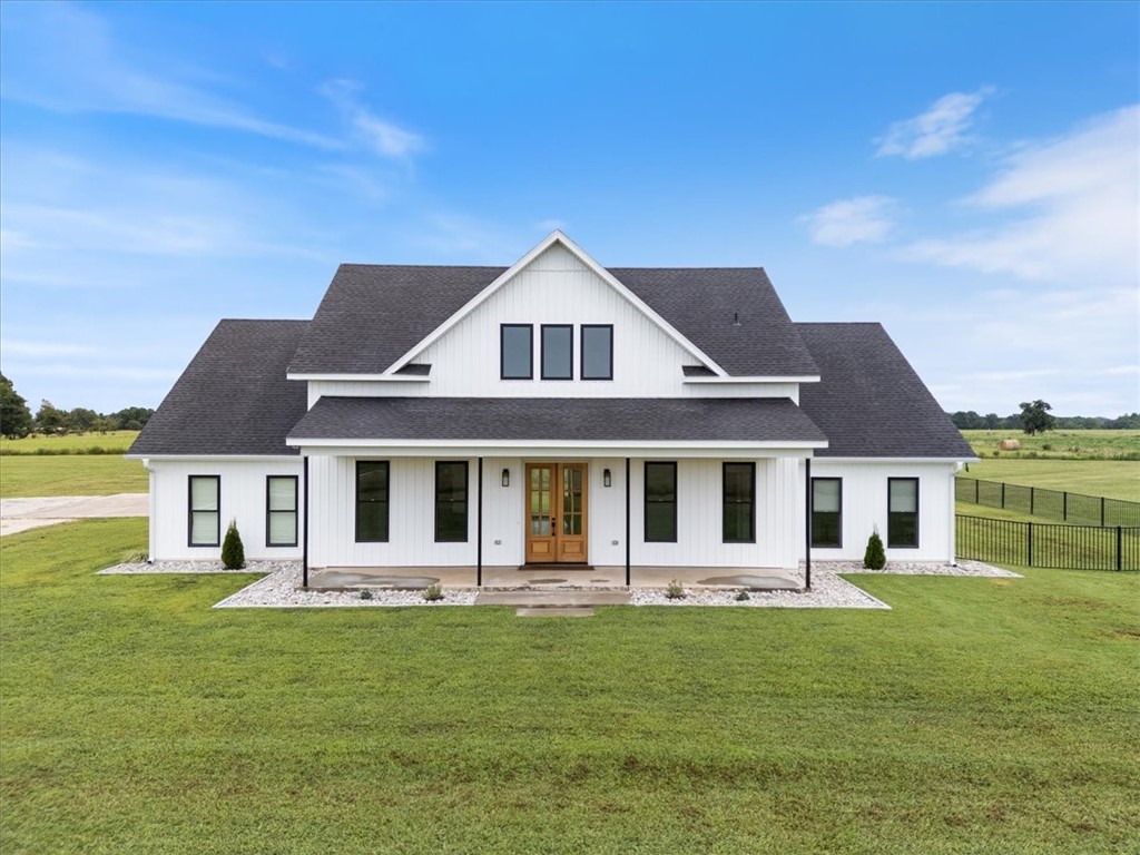 Welcome to this immaculately cared for custom built home just outside the Pea Ridge city limits. Peacefully located on 3.68 acres of flat, cleared land this modern farmhouse is absolutely gorgeous and thoughtfully designed. Boasting 2 covered porches to enjoy the natural beauty of the land and the stunning sunrises and sunsets. A large open kitchen with plenty of cabinets and a spacious walk-in pantry. A formal dining room right off the kitchen makes entertaining a breeze. The living room has a propane fireplace with built-ins on both sides. The primary bedroom is situated on the main floor, along with 2 additional bedrooms. The 4th bedroom on the 2nd floor has an ensuite, potentially making it a second primary if needed. There is also a dedicated exercise room on the main floor as well. The fully fenced in backyard will keep the kids and fur babies from exploring a little too far! Don't let this one get away, schedule your showing today!