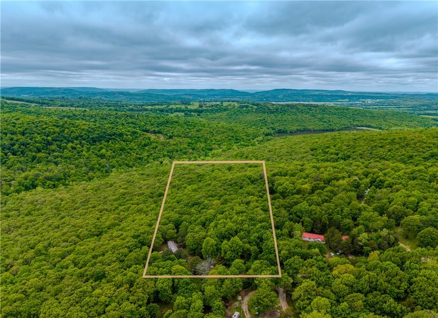 Opportunity meets acreage just outside Fayetteville. This 5-acre parcel offers a blend of privacy, usability, and flexibility with approximately 4 wooded acres and 1 cleared acre already in place. Utilities include water, electric, and existing septic, providing a strong head start for future plans. Manufactured homes are permitted, making this an excellent option for a primary residence, investment hold, or new homesite with room to spread out. Tucked in a peaceful setting with convenient access to Fayetteville amenities while still enjoying the feel of country living. Located in the Greenland School District. Hard-to-find small acreage with utilities already on site and multiple possibilities. Uninhabitable structure and personal property remain on site; buyer to verify condition/removal.