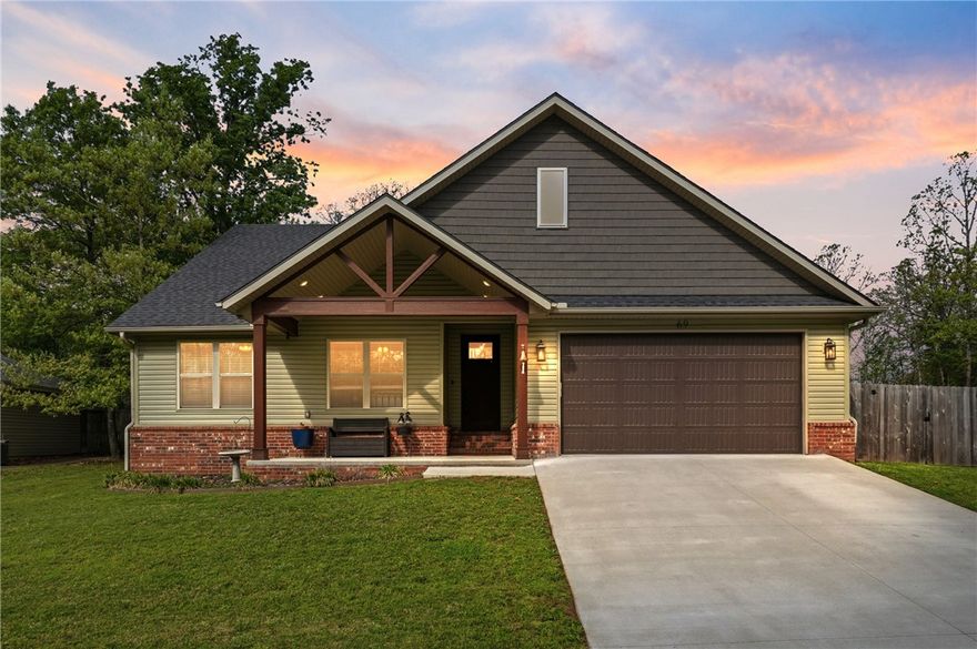 Experience the perfect blend of comfort and craftsmanship in this beautifully designed custom Craftsman home built in 2023, ideally located just 7 minutes from I-49 for easy access to all Northwest Arkansas has to offer. Inside, you’ll find a open-concept layout with a desirable split floor plan, creating both functionality and privacy. The living area is the true heart of the home—featuring a stunning vaulted ceiling with stained wood beams and a cozy fireplace that sets the tone for relaxing evenings or entertaining guests. The kitchen and living spaces flow seamlessly, and the home comes move-in ready with included appliances and window blinds already in place. Located just minutes from Lake Loch Lomond, Highlands Golf Course, and the Scotsdale Activity Center, this home offers not only comfort but a lifestyle surrounded by recreation, nature, and community.