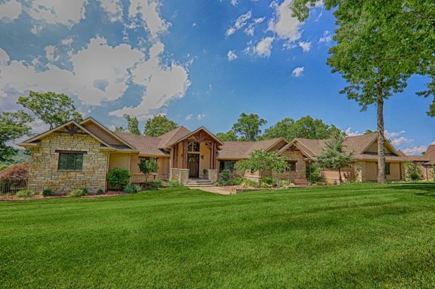 STUNNING LAKEFRONT MASTERPIECE!! CUSTOM BUILT 4 BR/3 FULL BA/2 HALF BA ESTATE NESTLED ON A 2.54(+/-) ACRE PARK-LIKE SETTING OVERLOOKING BEAVER LAKE IN THE PRESTIGIOUS ESCULAPIA ESTATES! 2 slip boat dock co-owned w/one other party! Extensive amenities including custom woodwork throughout, vaulted wood beamed ceilings, wood flooring, copper soaking tub, gourmet kitchen, open living/dining area w/sweeping views of the lake, 2 workrooms, main level master suite, elevator & large walk-out basement featuring large media/game room w/wet bar, huge workroom, 2 BR, full & half BA, & lots of storage! This meticulously maintained estate is SIMPLY SPECTACULAR!