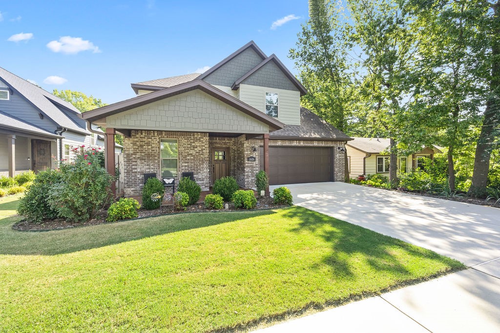 Ravishing home in the Parksdale Subdivision! Modern elegance w/ wonderful natural light create the warm and inviting ambiance we all want. Expansive open living space featuring vaulted ceilings w/ stunning wood beam accents and a charming gas-log fireplace. Seamless flow continuous into eat-in kitchen and dining w/ ss appliances, tiled backsplash, pantry w/ barndoor and center island. Granite countertops featured throughout. Primary bedroom located on main level, has beautiful wood accent beam, walk-in closet w/ built-ins, custom tile shower and dual sink vanity. Spacious bedrooms located upstairs. Private fully fenced backyard inc covered patio w/ for relaxation and outbuilding w/ electric gives space for projects. Adorable bridge leads you to wooded area. Solar panels help to keep energy costs low. Location is unbeatable - close to shopping, dining, entertainment w/ University of Arkansas only 3 minutes away. Greathouse Park trails are moments away. Easy access to both I-49 and 71-B. Must see this beauty today!
