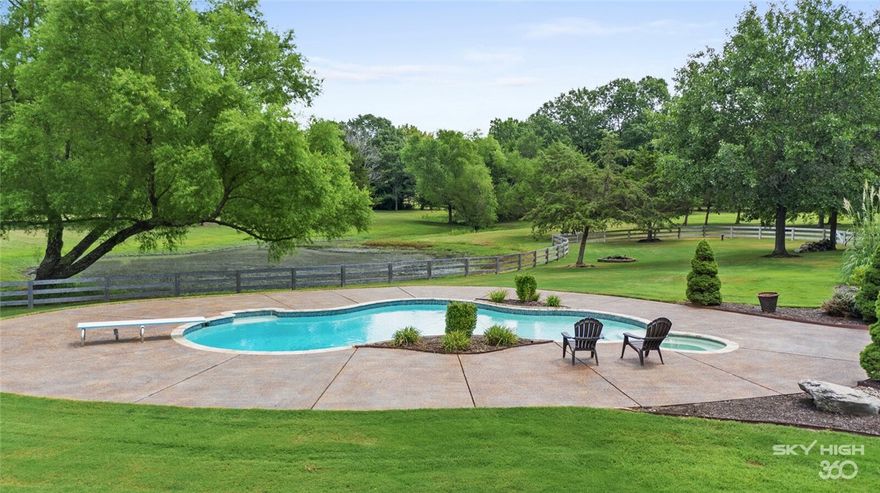 This 7.62 Acre estate captivates essence of country living w/city convenience. Privacy awaits along tree lined drive of this 5 BR, 4.5 bath residence w/private pond. Beautifully proportioned for entertaining featuring floor-to-ceiling windows throughout, gracious entry w/formal living & dining, wet bar & handsome elevated study. Heart of the home is the gourmet kitchen & bkfst area opening to a fireside family room. Owner’s suite w/luxurious bath & tasteful addition boasting office/exercise room, redesigned closet of elegant wood finishes & detailed millwork w/quiet space for meditation/library/reading or dressing area. Guest ensuite w/pool access completes main level. Venture upstairs to access 3 other generous guest suites w/baths & recreation/media room w/2nd kitchen. Outdoor oasis w/sparkling pool & verandas overlooking lush grounds ideal for gatherings. New 1220 ft irrigation well & 16x36 outbuilding. Extensive exterior renovation of James Hardie Siding plus abundant updates. Call your agent for complete list.