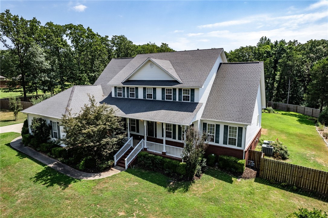 Spacious and private 5 bedroom, 3.5 bath home on 2.5 acres just outside of Alma. Peaceful setting with mature shade trees, numerous flowers, fruit trees, and berry plants. Granite tile counter tops in the kitchen, newer appliances, pantry, & ample cabinetry. Hardwood flooring in most of the main level. Oversized living room with gas log fireplace. Master suite is downstairs with a custom tile shower, huge tub, dual sinks, and walk-in closet with built-ins. Formal dining, breakfast nook plus an office. Laundry room features a sink and lots of storage space. Upstairs you'll find a second living room, 4 bedrooms and two full baths (one is en suite). The screened-in back porch and covered front porch allow you plenty of exterior living space to enjoy the view of your tranquil yard. Two-car side entry over-sized garage, greenhouse and bonus crawlspace storage area.