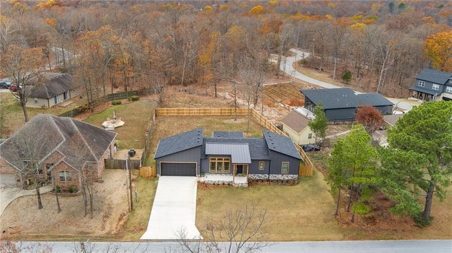 Welcome to this beautifully maintained modern home in Bella Vista, offering a clean, open layout and thoughtful upgrades throughout. Built in 2023, this property features luxury vinyl plank flooring, quartz countertops LED lighting, and a spacious kitchen deigned for everyday living and entertaining. The primary suite includes a walk-in closet and a large walk-in shower with contemporary finishes. Enjoy the private fenced backyard with a wooded view a covered patio, and low-maintenance landscaping - perfect for relaxing and hosting. Conveniently located near the Branchwood Fitness Center, bike trails, walking paths, and all the outdoor amenities Bella Vista is known for.  This home is move-in ready and offers an outstanding opportunity in a highly desirable area.