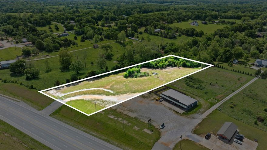 Prime commercial opportunity!  2.98 acres of level, mostly cleared land with 219 ft of highway visibility and a strong daily traffic count of 14,000 (8% commercial traffic) - ARDOT. Positioned along Hwy 62, a key connector of NW AR and SW MO, this site offers consistent drive-by exposure. Zoned commercial and ready for development, the property features a paved entrance plus a 25' double access easement off of Hwy 62 shared by other businesses (see survey), making it ideal for easy on/off Hwy access for boat, trailer and other vehicles frequenting your business. A short commute from Lost Bridge Marina, Pea Ridge National Military Park, and downtown Rogers, captures both recreational and commuter flow. Strategically located to attract Northern Beaver Lake traffic. Positioned in Garfield city limits for you to take advantage of the growing community. City water and electric available (on-site septic needed). Strong investor appeal with endless potential to establish or expand your business in a high-growth area.