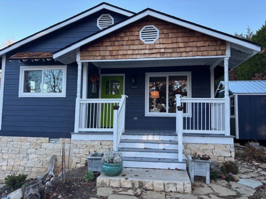 BREATHTAKING VIEWS of the lake and mountains year round!  This Holiday Island home sits on an unusually large lot that feels spacious and remote, while still being close to shopping, golf and neighborhood amenities.  This beautifully remodeled cottage features lush finishes:  new windows and doors, granite countertops, new flooring and live-edge wood shelving, all new stainless steel appliances and water heater.  A new gas fireplace makes winter days feel cozy.  The gorgeous brand-new wooden upper-and-lower decks feature stunning views year-round, with an adorable cowboy/cocktail pool on the lower level.  Just across the street from walking trails, and minutes from the Holiday Island Campground in one direction and the Holiday Island Marina in another.  This would make a lovely residence OR a fabulous getaway cottage.  Ideal for nightly rental.  Call to see it today!