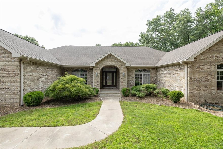 This stunning Bella Vista home is immaculate and located on a cu-de-sac in a prime location only a 3 minute ride to the Tunnel Vision Trail. Featuring a bright neutral color scheme, this 3 bedroom retreat sits on 3 lots totaling 1.13 acres +/-. Enjoy the 2-year old heated saltwater pool or a soak in the hot tub after your fun day of trail riding or hiking. With a formal dining room, bright window laden living room, kitchen that opens to the huge window wrapped family room, and darling cedar screened in porch, this house is perfect for entertaining guests or family home. The basement workshop is perfect for tuning your bikes, all hobbies or storage. A large 3-car garage has a professionally installed epoxy floor. The landscaping is beautifully designed with redbuds, dogwoods, Japanese maples and a nice mic of hardscaping and level grass courtyard. The home was most recently used as a short term rental and was popular among traveling cyclists. It can come turnkey with furnishings. 26 minutes to Walmart home office