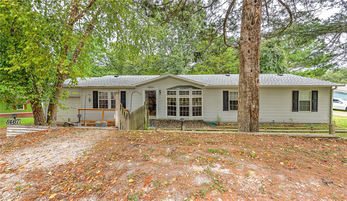 Charming Double Wide Near Lake with Spacious Living Areas! This inviting 4-bed, 2-bath double wide home is located near Prairie Creek in a community that offers the benefits of a Homeowners Association. Situated on a large lot, this property offers privacy and plenty of room to enjoy the outdoors. The well-cared-for home features an open floor plan with a large dining area, perfect for family gatherings & entertainment. Cozy gas fireplace provides warmth & charm to the living room. Enjoy the sunshine year-round in the large sunroom; or enjoy the local birds outdoors on the two spacious decks. Not only does this property offer a home warranty, but all appliances also convey, making moving in a breeze. The entertainment center stays, & other pieces of furniture are negotiable, offering flexibility for your furnishing needs. The drapes also convey, adding to the home's ready-to-move-in appeal. This home is perfect for those looking to enjoy lake-area living with plenty of space for relaxation and entertainment.