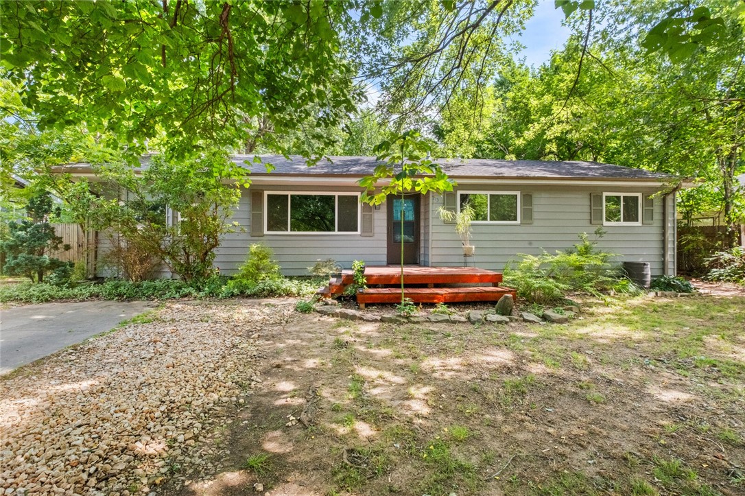 This sweet 3 bedroom, 1 bath house has original, wooden floors, completely updated throughout in 2017, 2 living areas, & a beautiful backyard perfect for the urban farmer. New roof & all new HVAC systems 2017. There are several raised garden beds using only organic, a fenced chicken yard with chicken house only fed organic food, a deck for lounging or grilling, a storage shed, & a fire ring. There is a natural and private feel to the space. The front yard has many select, native plants and trees including a giant redbud. Close proximity to greater shopping areas, 2 natural foods grocers, & interstate access, but is surprisingly quiet & feels like a little slice of heaven with the lush, natural beauty. The parking area in front of the house can fit 5 vehicles. The neighborhood is full of giant, old trees and plenty of families walking beneath them. A 10 minute walk will bring you to the bike trail system & Scully Creek views. It takes 5 minutes to drive to Gulley Park, Lake Fayetteville, & the Botanical Gardens.