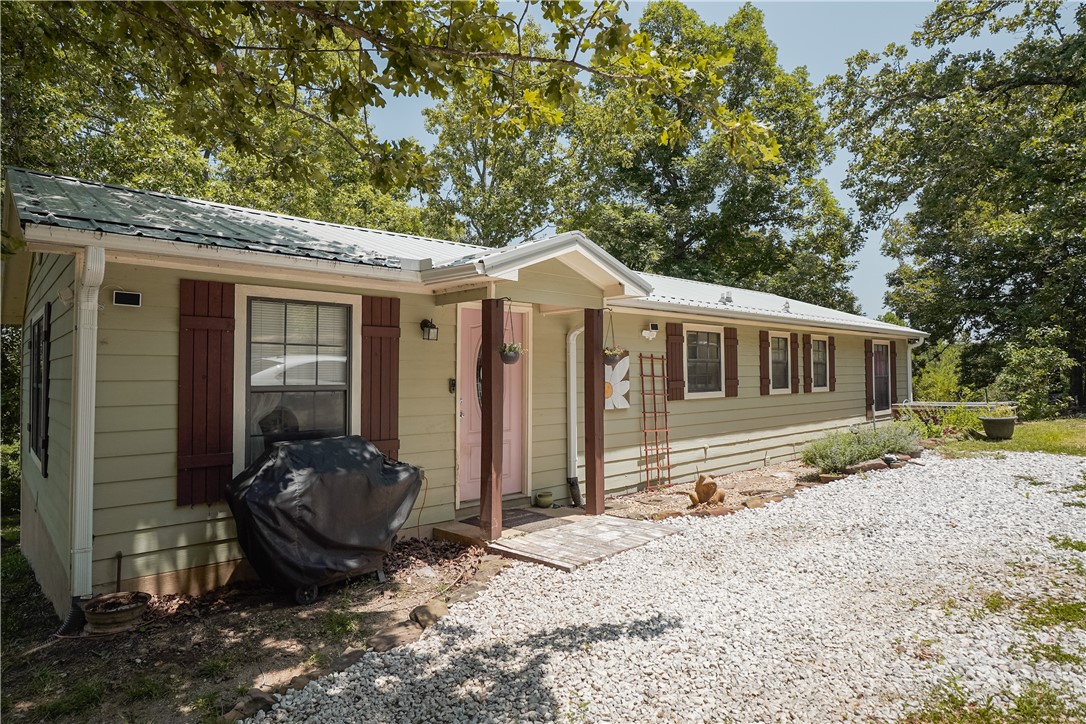 This property presents a one-of-a-kind opportunity with a beautiful home with a large front porch and second build site already set up with utilities and an even more beautiful view. Located just three minutes from the bypass, come live in the existing home and build your forever dream home. Existing home would make an great rental property once your dream home is built. Current home has trey ceiling and dimmable recessed lighting, open kitchen, living room and dining, plus multiple out buildings. A/C and appliances new in 2018, metal roof in 2022, gutters with leaf guard in 2022 and porch in 2021. Donāt let this one slip away!