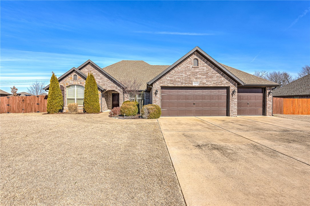Exceptional Rogers home in an unbeatable location! Meticulously maintained, this stunning all-brick with rock detailing home boasts well-established landscaping in both the front and back yards, a spacious 3-car garage, and notable features like a charming brick wood-burning fireplace on the back patio covered by a pergola surrounded by a wood fence for privacy. Inside, the home is thoughtfully designed with a split floor plan, elegant crown molding, plantation shutters, granite countertops, and a formal dining room.