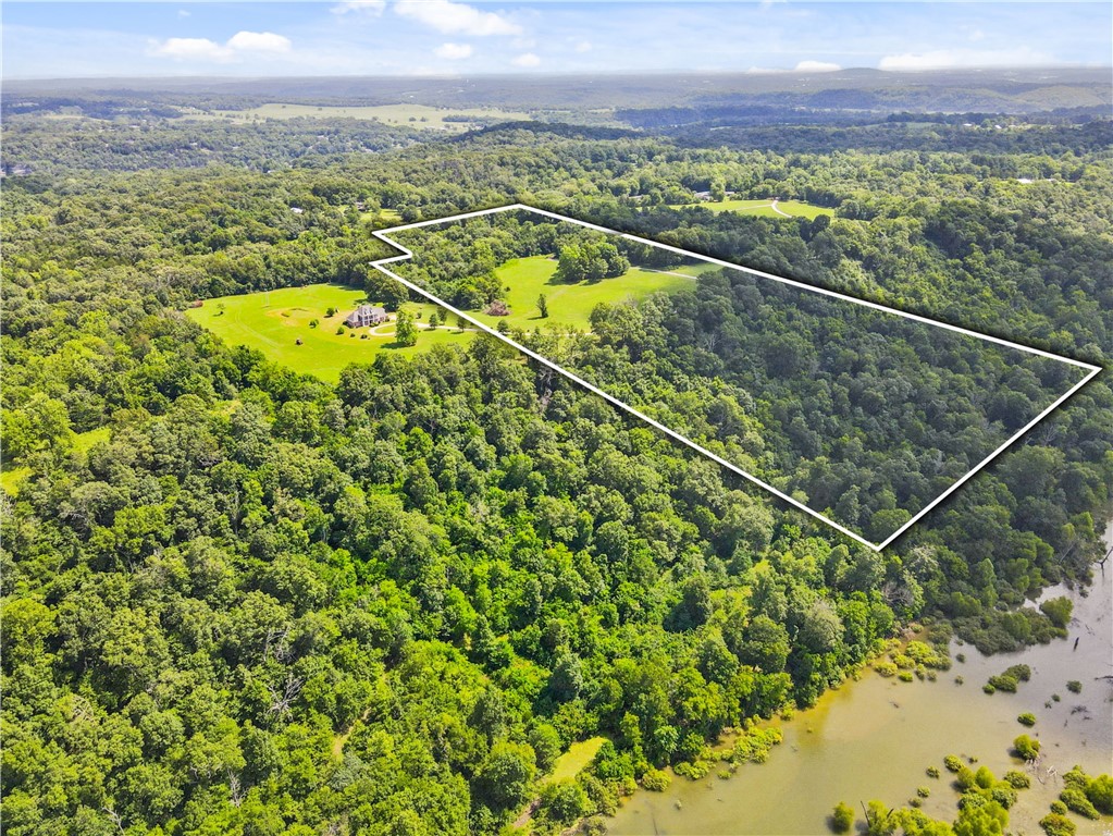 With some of the most stunning views of the White River in all of Northwest Arkansas, build the house of your dream with views that can't be beat. This place is like a breath of fresh air, an escape where life slows down and peace finds you. Nestled along charming country roads, with plenty of acreage, shade trees, open fields, fishing, and everything you need. City water is at the street and at the adjacent lot and word is that it will be able to be tapped in by the end of this year. Book an appointment, spend some time out here, and fall in love—just like we did.
