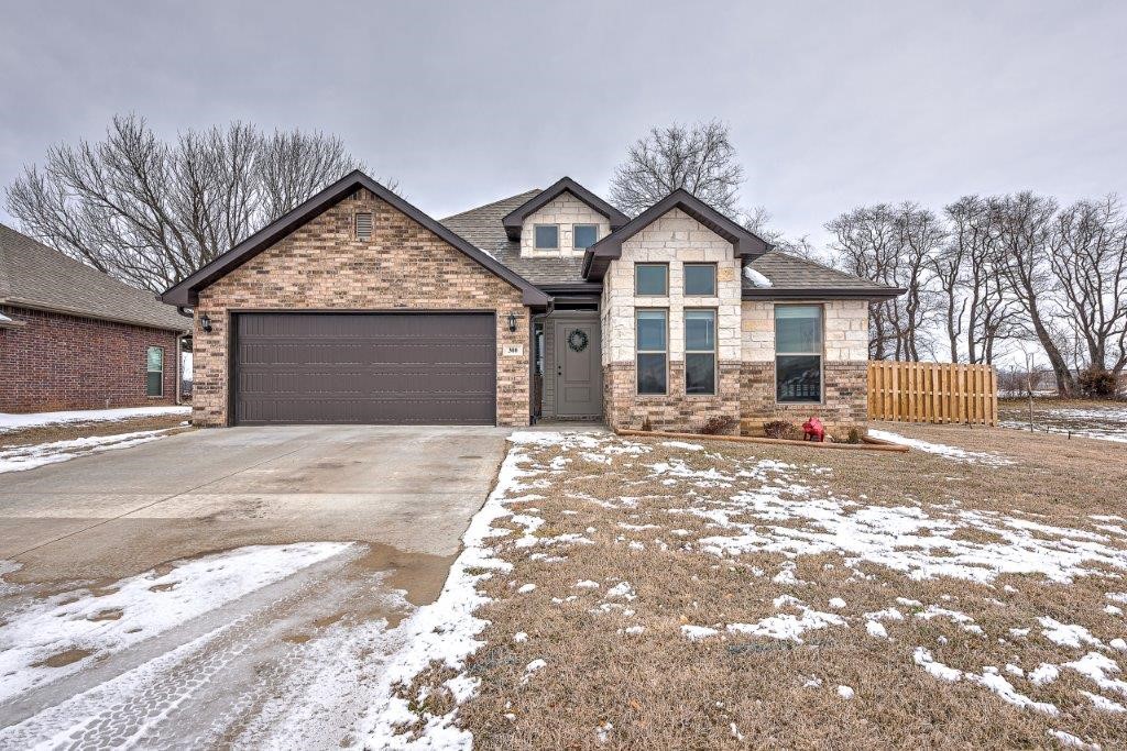 Gorgeous 3 bed 2 bath home, just minutes to Bentonville or Rogers, and I-49! Amazing and spacious open floor plan, with lots of natural light! Immaculate and pristine, with beautiful granite and modern wood look tile floors! Featuring high ceilings, and also a spectacular tray in master! Large granite center island with bar, and a gas range! Walk-in pantry and extra storage in laundry! Cozy electric fireplace and lovely arched doorways! Large covered patio and very spacious back yard for entertaining! There is even extra space to the right of this lot, which gives it extra privacy! Charming brick and stone exterior gives an added designer touch! Home is in an excellent centrally located NWA location and is an absolute must see!