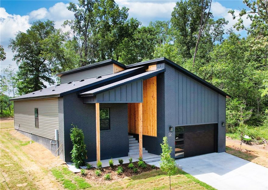 Near Loch Lomond—Bella Vista’s largest lake—Stoneykirk boat launch & Branchwood Rec w/ indoor pool, fitness center & pickleball courts, this newly built home puts lakes, trails & family fun at your doorstep. Surrounded by natural beauty, it delivers instant calm & everyday ease. A warm wood entry opens to a bright, open-concept layout designed for connection, comfort & effortless living. The kitchen includes granite, SS appliances, walk-in pantry & inviting eat-in nook—ideal for slow mornings or weekend hosting. LVP flooring, curated lighting & contemporary finishes create a polished, welcoming feel throughout. The primary suite provides a peaceful retreat w/ a walk-in closet, while laundry room & recirculating hot-water system add convenience. Step onto the covered back porch to enjoy quiet mornings, relaxed evenings & a level backyard ready for play or gatherings. A 2-year builder’s warranty adds peace of mind.  Use the preferred lender & get a $3500 credit.  The garage door opener has a backup battery too!