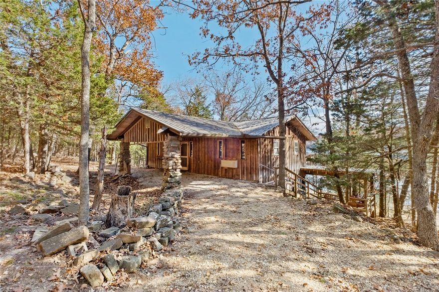 Great opportunity to own a cozy Beaver Lake Front Cabin nestled in the serene Lazy "J" Ranch Estates with a private 4 slip (10x26 slips) dock with swim deck right in front of your home. The setting and location are perfect for the nature and water lovers. This property offers 2 bedrooms, 2 bathrooms, game room, family room, and a wood burning fireplace. Two  outdoor areas to enjoy year round views of the lake. The oak siding on the home was milled from trees removed from the land for building.
Seller is offering this property "As-Is" no repairs.