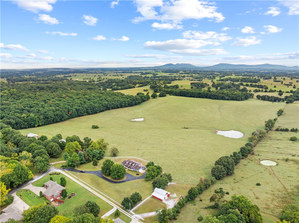 One of the most beautiful farms in Boone County, Harrison, AR, near the Buffalo National River and just 30 minutes to Branson, MO, offers 72 picturesque acres. Enjoy sunsets over the Ozark Mountains from the pastures raising livestock on the 72 acres. Consider the development opportunities. The acreage is accessed on an owned vacant lot off Creekwood Rd. Located just outside the city limits, this farm is only 2 minutes from the Creekside Regional Community Center, making it a perfect blend of rural serenity and modern convenience.