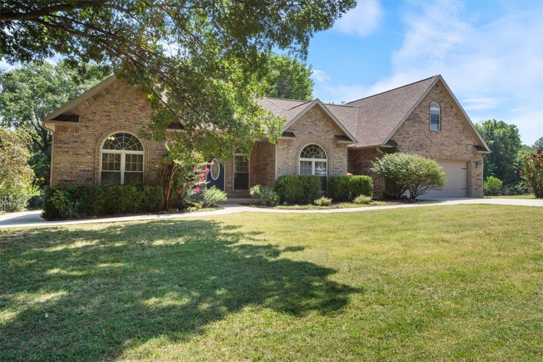 Looking for a home tucked away on acreage and can't seem to find the right home in those cookie cutter neighborhoods! Look no further, this one offers beautiful charm and character inside and out. Lofty ceilings with gorgeous crown moulding makes the entrance welcoming to any guest or any buyer looking for a place to call home. Updates include: Quartz countertops, wood flooring in 2 bedrooms, kitchen cabinets painted, extended concrete patio in the backyard, new stainless steel dishwasher, convection oven microwave combo, and water heater 2023. This 3 bedroom 2 bath home with bonus room offers available expansion area over the garage for storage, a 4th bedroom, an office, workout room or theatre room. The back covered patio will provide ample shade from the sun. Peaceful scenery backing up to a wooded ravine making space and care for the acreage VERY manageable. Oversized Extra deep garage stall and plenty of driveway parking spaces. Only 2.3 miles to Beaver lake public boat ramp. Plumbed for Central vac.