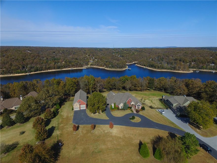 Stunning Lake Front home on 3.3 acres with private community boat dock, 5 BR, Library/Office, nice upstairs workout/Bonus room.  Darling detached studio PLUS detached 1,750 square foot modern décor apartment with RV parking and garage parking.  Outdoor living space with fireplace and beautiful lake view.  Many amenities!!!