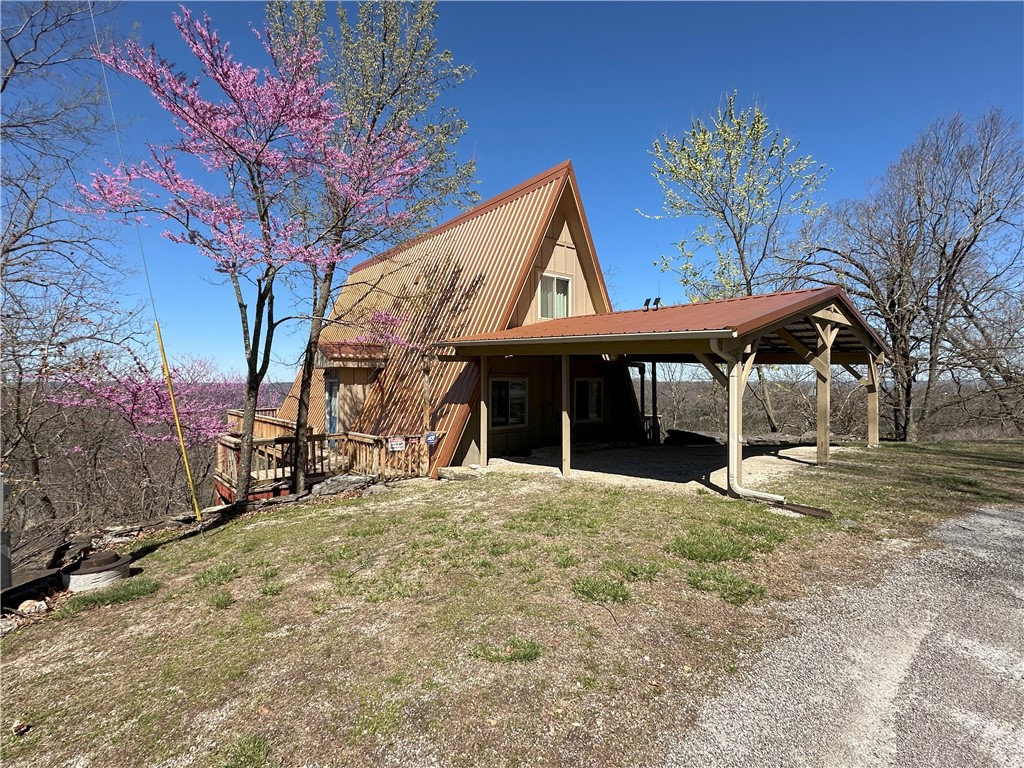 Welcome to the "Eagle's Nest"! This A frame style home was built in 1975 & was known to the locals as a place to sit & watch the Eagles fly! The exterior has great curb appeal w/its copper metal roof (new 2013), wrap-around deck, & private upper deck offering some of the best views in Holiday Island. Did I mention it comesĀ Fully Furnished? That's right, it isĀ move in ready from the furniture, bedding, & even fresh towels! The living area has a propane fireplace & shows off the beautiful wood beams, wood work & matching vintage lights. The kitchen is complete w/Granite countertops, all appliances, dishes, & silverware. The main level has 2 beds & 1 bath, while upstairs offers the master suite w/full bath & private exit to the upstairs deck! Owners have made the following upgrades: Anderson Silverline Windows, Pella Doors, new sewer lines from the house to City connection, new Hardy Board Siding, new composite decking on upper deck & lower staircase, & 3 new mini splits in 2023 . Act Now & get the mower too!