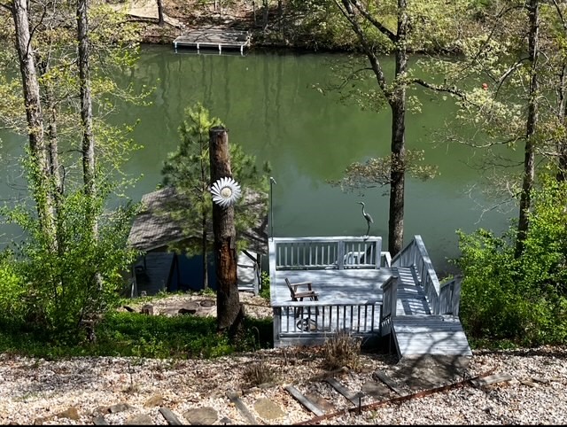 Lake Front on popular Lake Windsor! Covered Private Boat Dock! Huge Decks and Covered Patio! Peaceful Culdesac. Natural Setting. Home is Comfortable/Spacious. Large Windows provide Natural Light. 2 Living Areas (1 on each level). Granite Counters. Main level has Office with Closet. Downstairs has space for Office, Exercise, etc. Also, a heated/cooled room for Storage or Workshop. Lots of Storage Space! Cork flooring in main living; other areas have luxury vinyl, ceramic, wood, carpet. Walk-in Shower & separate Soaking Tub. Large primary bedroom with Walk-In Closet. 3 Solatube Skylights. Roof 5 yrs. HVAC 4 yrs (heat pump). New garage door & new opener. Sloped yard provides a wonderful lake view. Landscaped Steps to Boat Dock. Close to Bike Trails (1.5 mi to new downhill bike park). 5 minutes to Fitness/Rec Center. Close to Tanyard Creek Nature Trail/Waterfall & to Bella Vista amenities: golf, tennis, swimming, parks, playgrounds, clubhouse, country club. Close to shopping, restaurants, business, medical facilities.