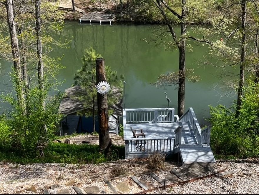 Lake Front on popular Lake Windsor! Covered Private Boat Dock! Huge Decks and Covered Patio! Peaceful Culdesac. Natural Setting. Home is Comfortable/Spacious. Large Windows provide Natural Light. 2  Living Areas (1 on each level). Granite Counters. Main level has Office with Closet. Downstairs has space for Office, Exercise, etc. Also, a heated/cooled room for Storage or Workshop. Lots of Storage Space! Cork flooring in main living; other areas have luxury vinyl, ceramic, wood, carpet. Walk-in Shower & separate Soaking Tub. Large primary bedroom with Walk-In Closet. 3 Solatube Skylights. Roof 5 yrs. HVAC 4 yrs (heat pump). New garage door & new opener. Sloped yard provides a wonderful lake view. Landscaped Steps to Boat Dock. Close to Bike Trails (1.5 mi to new downhill bike park). 5 minutes to Fitness/Rec Center. Close to Tanyard Creek Nature Trail/Waterfall & to Bella Vista amenities: golf, tennis, swimming, parks, playgrounds, clubhouse, country club. Close to shopping, restaurants, business, medical facilities.