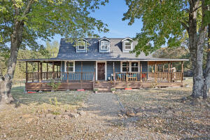 Step into your perfect country haven with this delightful two-story, barn-style home set on 2.18 acres. Featuring 4 spacious bedrooms and 2 beautifully appointed bathrooms, this 1,624 sq. ft. home offers the perfect blend of comfort and style. The main level features a cozy living room, followed by a completely updated kitchen, and a primary bedroom conveniently located next to a bathroom with a deep soaker tub. Upstairs, you'll find three additional bedrooms and a full bath, perfect for family or guests. Outside, dive into relaxation under the expansive wrap around porch, or next to your pool, and utilize the detached garage and heated and cooled workshop for all your hobbies. Experience country living at its finest!