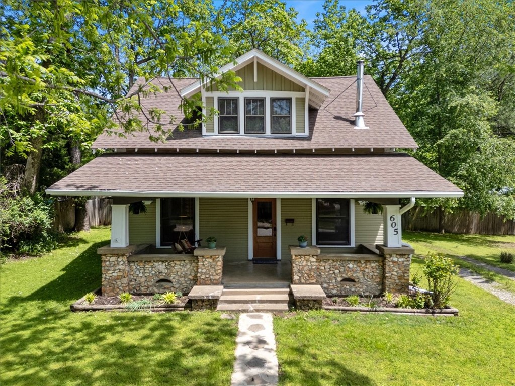 FULLY FURNISHED! Charming Historic Home in Prime Downtown Siloam Springs Location! Step into the charm of the early 1900s with this beautifully maintained historic home, ideally situated just three blocks from vibrant downtown Siloam Springs. Enjoy the convenience of being within walking distance to three scenic city parks, peaceful walking trails, coffee shops, & a variety of local restaurants. This home blends classic character with modern updates. Gorgeous original wood floors & tastefully renovated bathrooms; spacious utility room. Outdoor living is a dream with a large covered front porch, a screened-in back porch perfect for relaxing evenings, and a generous deck that leads to a garden area and privately fenced backyard. Additional features inc a detached garage/shop with ample workspace, a dedicated workroom, and mature landscaping that enhances the property’s curb appeal. ALL FURNISHINGS INCLUDED IN THE PRICE! IF FURNITURE IS NOT WANTED, SELLER WILL NEGOTIATE.
