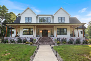 This is one of the most amazing, stylish, well bult, beautiful contemporary homes around!Luxury combines with comfort to in this rare find! So many extras, so much quality and thoughtful construction that there is literally not enough space to list them all. Huge open space great room, with double fireplace that makes the huge custom back porch a perfect outside living area, complete with hot tub and entertaining space. Chef quality kitchen with quartz counters. Master suite downstrs boasts a dbl sinks and make up station plus a huge walk-in closet! Upstairs 3 or 4 bedrooms, one of them a Master suite w/bath and makeup station, a unfinished bonus area, a den area and two full baths. 10' ceiling downstairs, 9' upstairs, tankless water heater, Thor propane stove, and Many other features