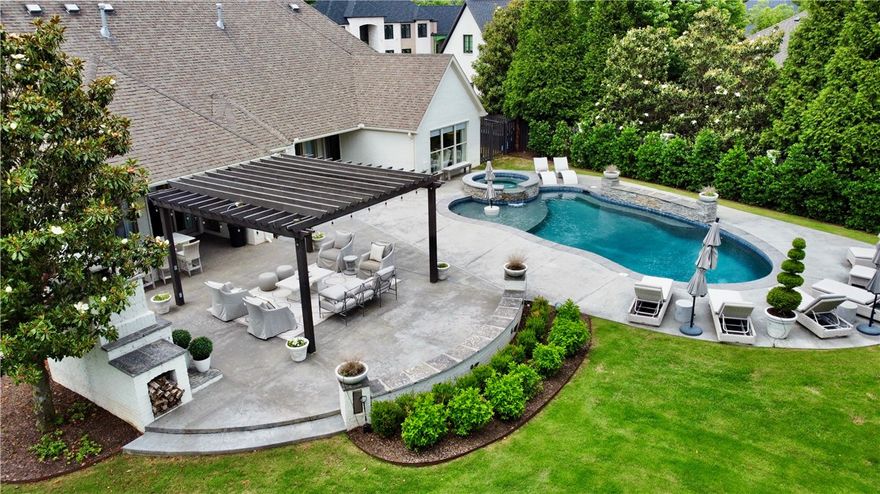 Hard to find, one level updated 3500 SF home on over half acre in Pinnacle! This stunning home has been completely remodeled with sophisticated finishes, designer lighting, custom drapes, new tile in all bathrooms, & hardwood floors throughout. Oversized owner's suite with lovely views, private access to pool, and luxurious spa-like bathroom with dual vanities, make-up space, & large his & her walk-in closets. This home has 2 bedrooms that share a jack-n-jill bathroom & an additional en-suite bedroom with 2 closets. Desired floorpan also features a home office with built-ins, formal dining, formal living room, & additional powder bathroom. Exterior of the home has beautiful painted brick, mature landscaping, & Bevolo gas lanterns. The professionally designed backyard oasis is an entertainer's dream with gunite pool with hot tub, pergola, wood fireplace, & outdoor kitchen.  Side entry 3 car garage is climate controlled with epoxy coated floors & built ins. Control 4 home automation & surround sound throughout.