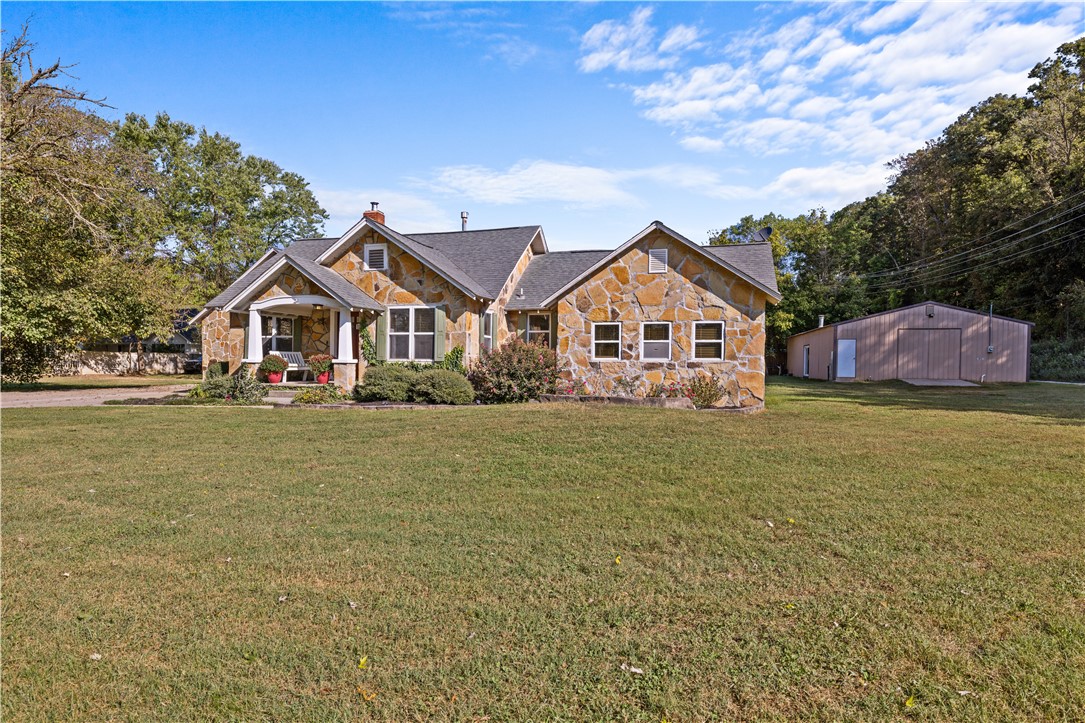Welcome home to 10198 Sugar Creek Rd. Discover this timeless home just 5 minutes from I-49 and 8 minutes to Downtown Bentonville! This delightful property features 4 bedrooms, 3 baths, an office, and a dining area, making it perfect for family living. The property sits on the Bentonville and Pea Ridge school district which allows school choice between the two. Situated on 1.22 acres, the property features mature trees and easy access to the Big Sugar gravel bike trail right out your front door. An oversized garage offers ample storage, complete with stairs leading to the additional space. Plus, the shop building is a standout feature, offering 1,500 sq. ft. (30x50) of insulated space equipped with a wood stove, 110 and 220 wiring, on a separate electric meter. Own a piece of Bentonville where convenience meets nature!
