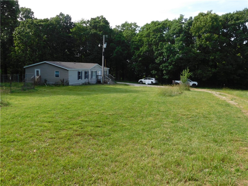 Nice 2004 mobile home that was remodeled in 2021. Nice LVP flooring throughout. Split floor plan, on a private 3.27 acres, over half in woods that slope from the house to Low Gap Rd. Roof was replaced in 2021, and water heater was replaced in 2024. Spacious kitchen and living room, double vanities in primary bedroom. See deer in your yard almost every day, and enjoy the peace and quiet, and yet not far from West Fork. Check it out!