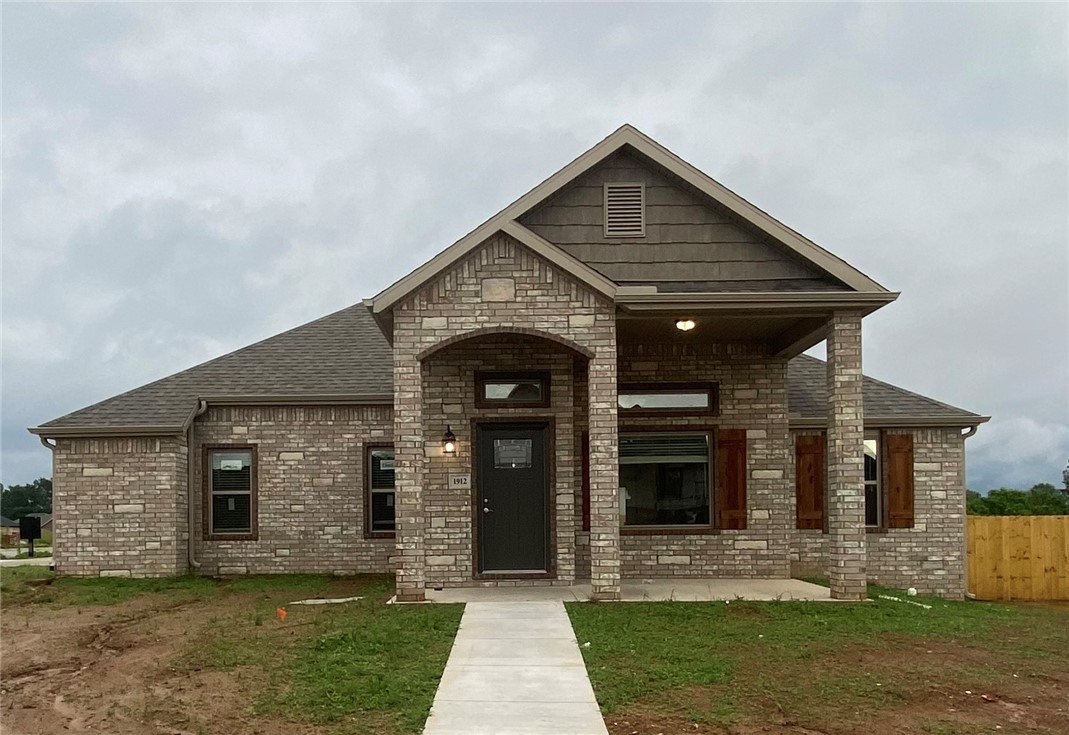 Stunning new constructionāthis single-story home features 3 bedrooms, 2 bathrooms, and a spacious 3-car garage. The kitchen is equipped with stainless steel appliances, a gas range, microwave vent hood, pantry, and granite countertops. A large fireplace flanked with built-in bookshelves serves as a striking centerpiece in the living room. Elegant details include wood-cased windows with 2-inch blinds throughout. Enjoy great curb appeal with a large front porch, fully sodded oversized yard, and a privacy fence. The covered back porch and fully installed gutters add both comfort and functionality. A keyless garage door pad offers convenient access. The primary suite boasts an oversized tiled shower and a walk-in closet that connects directly to the laundry room, located near the garage for added convenience. Durable brick exterior construction ensures longevity and low maintenance.